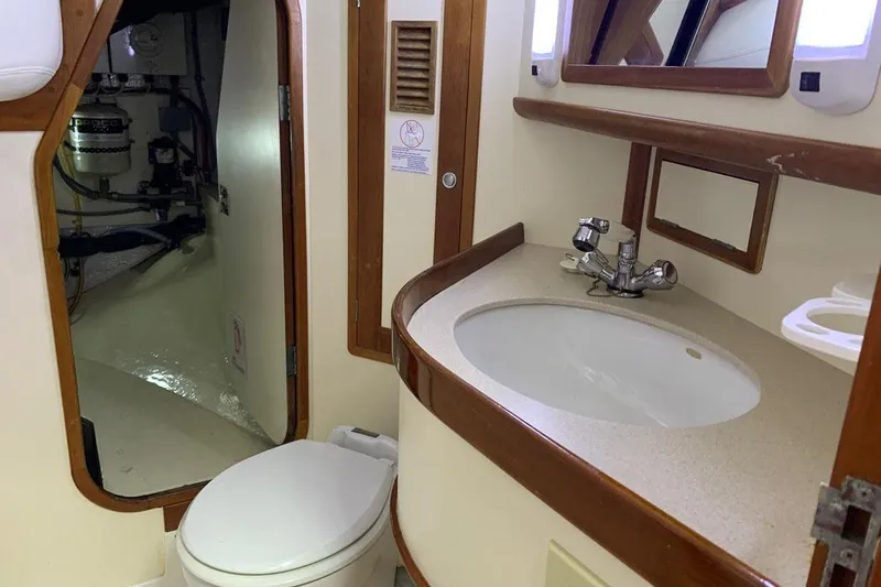 Tumblehome Yacht Photos Pics Bathroom interior of 1995 Little Harbor 51 Pilothouse yacht, featuring sink and toilet.