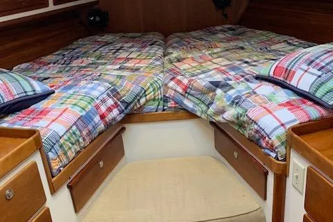 Tumblehome Yacht Photos Pics 1995 Little Harbor 51 Pilothouse cabin with colorful bedding and wooden storage drawers.