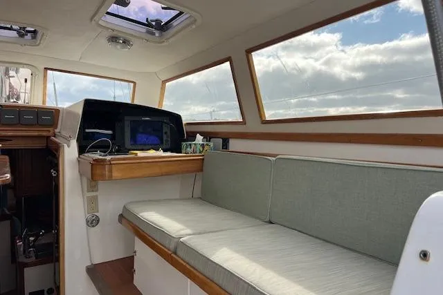 Tumblehome Yacht Photos Pics Interior of 1995 Little Harbor 51 Pilothouse with seating and navigation equipment.
