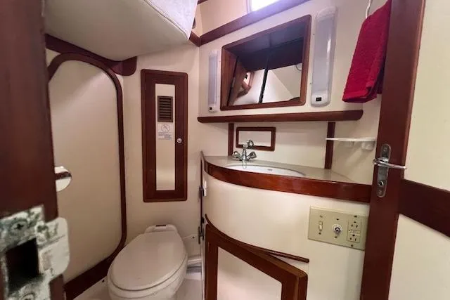 Tumblehome Yacht Photos Pics Bathroom interior of 1995 Little Harbor 51 Pilothouse yacht, featuring sink and toilet.