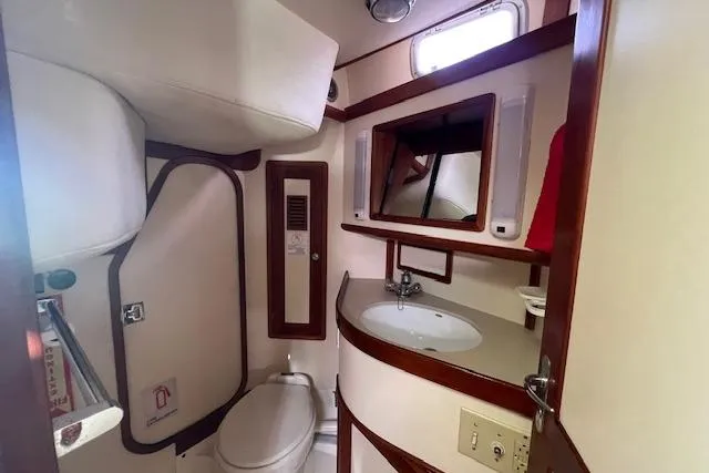 Tumblehome Yacht Photos Pics Bathroom interior of 1995 Little Harbor 51 Pilothouse yacht, featuring sink, toilet, and mirror.
