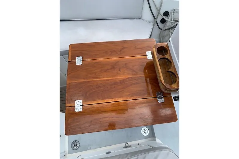 Tumblehome Yacht Photos Pics Wooden table with cup holders on a 1995 Little Harbor 51 Pilothouse yacht.