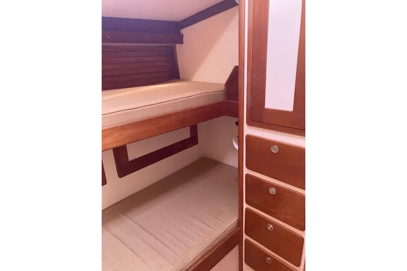 Tumblehome Yacht Photos Pics Interior of 1995 Little Harbor 51 Pilothouse with wooden bunk beds and storage.