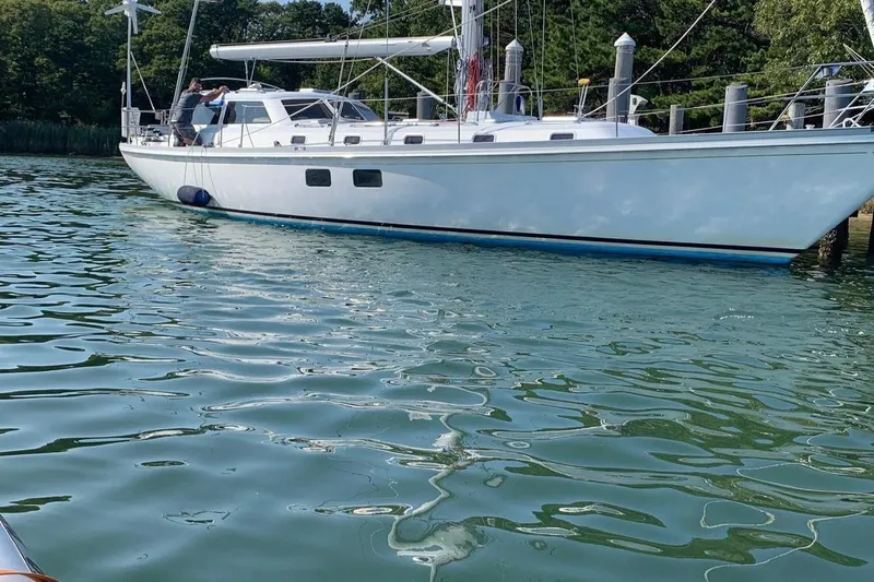 Tumblehome Yacht Photos Pics 1995 Little Harbor 51 Pilothouse yacht docked on calm water.