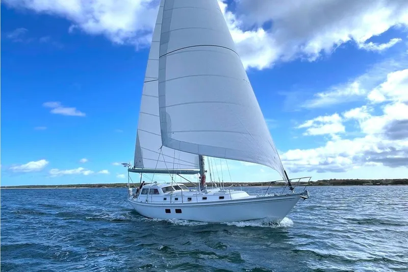 Tumblehome Yacht Photos Pics Sailing yacht Little Harbor 51 Pilothouse, 1995, gliding on open sea under blue sky.
