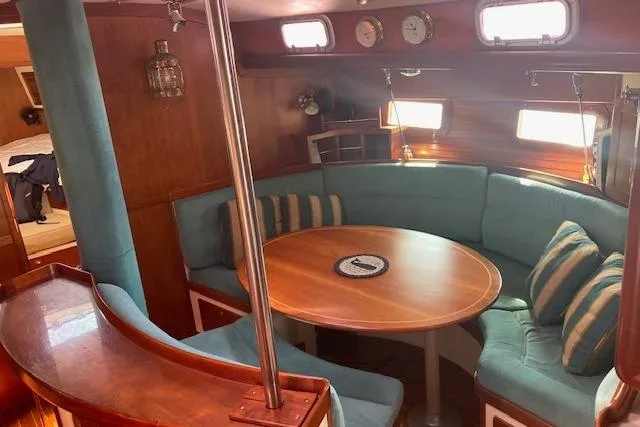Tumblehome Yacht Photos Pics 1999 Little Harbor 51 Pilothouse interior with cozy seating and wooden table.