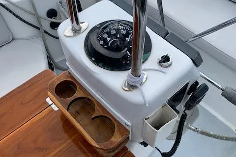 Tumblehome Yacht Photos Pics 1999 Little Harbor 51 Pilothouse compass and helm detail with wooden cup holders.