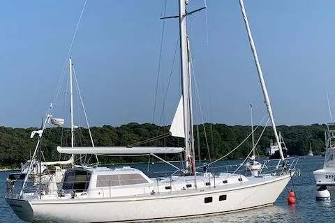 Tumblehome Yacht Photos Pics 1999 Little Harbor 51 Pilothouse sailboat anchored in a serene bay.