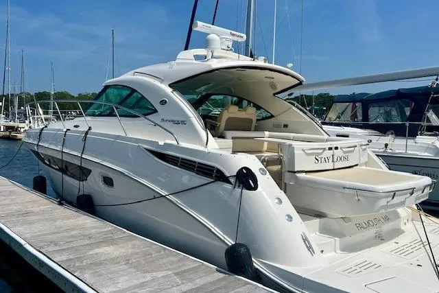 Stay Loose Yacht Photos Pics 2013 Sea Ray 410 Sundancer yacht docked at marina under clear blue sky.