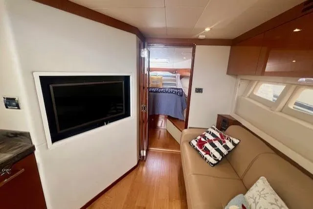 Stay Loose Yacht Photos Pics Luxurious interior of 2013 Sea Ray 410 Sundancer yacht with cozy seating and modern TV.