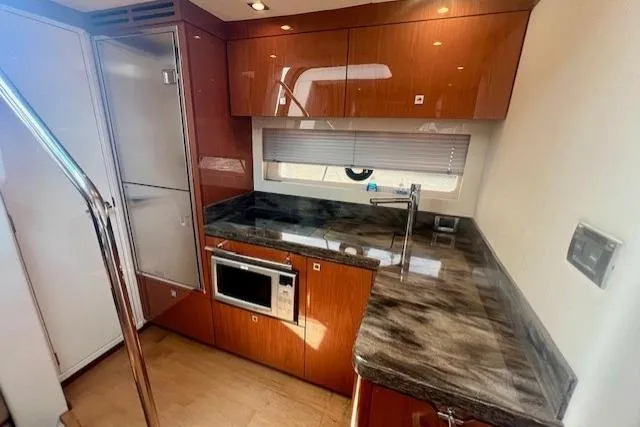 Stay Loose Yacht Photos Pics Luxurious kitchen interior of 2013 Sea Ray 410 Sundancer yacht with modern amenities.