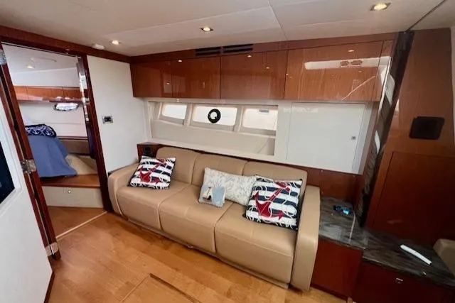Stay Loose Yacht Photos Pics Luxurious interior of 2013 Sea Ray 410 Sundancer yacht with leather sofa and nautical decor.