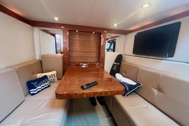 Stay Loose Yacht Photos Pics Interior of 2013 Sea Ray 410 Sundancer yacht with plush seating and wooden table.