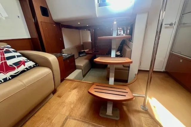 Stay Loose Yacht Photos Pics Interior of 2013 Sea Ray 410 Sundancer yacht with wooden steps and beige seating.