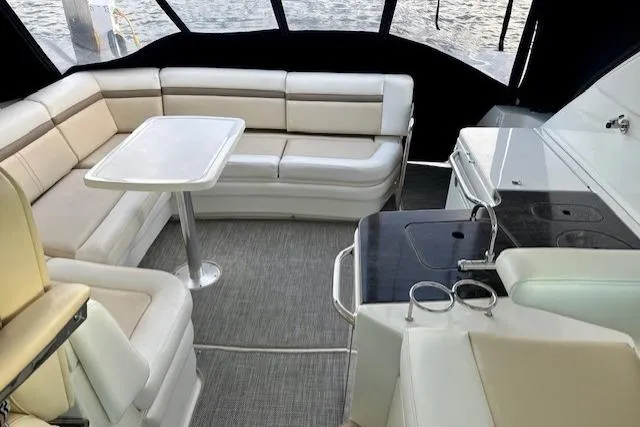 Stay Loose Yacht Photos Pics Luxurious interior of 2013 Sea Ray 410 Sundancer yacht with seating and kitchenette.