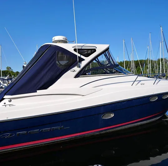  Yacht Photos Pics 2014 Regal 38 Express yacht docked in marina, featuring sleek design and blue accents.