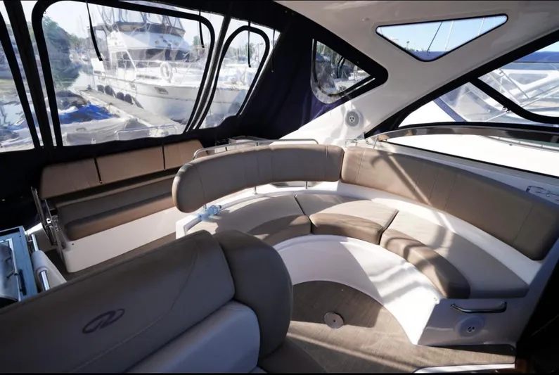  Yacht Photos Pics 2014 Regal 38 Express yacht interior with curved seating and large windows.
