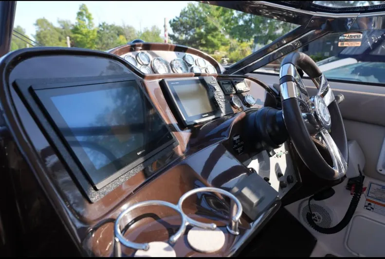  Yacht Photos Pics Cockpit of 2014 Regal 38 Express boat with modern navigation displays and steering wheel.