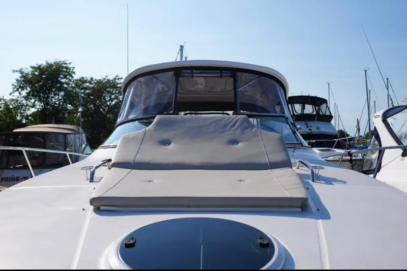  Yacht Photos Pics 2014 Regal 38 Express yacht with sunpad, docked in marina under clear blue sky.