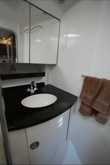  Yacht Photos Pics 2014 Regal 38 Express bathroom with sleek black countertop and modern fixtures.