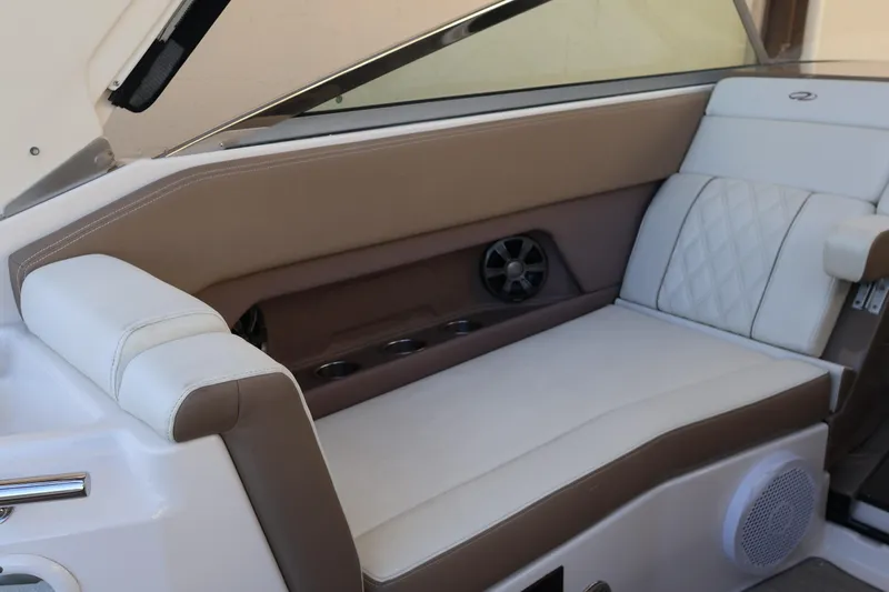  Yacht Photos Pics 2018 Regal 28 Express boat interior with beige and white seating, cup holders, and speaker.