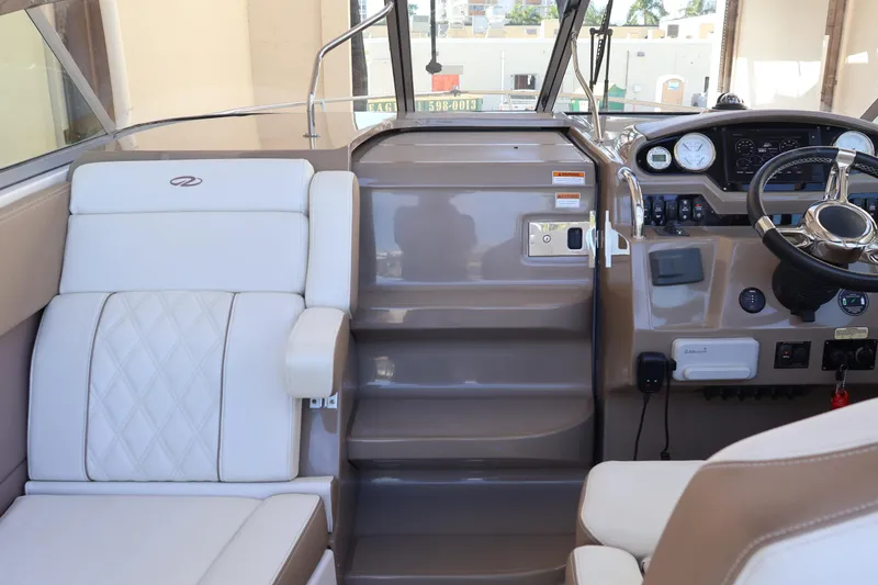  Yacht Photos Pics 2018 Regal 28 Express boat interior with steering wheel and seating area.