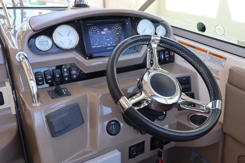  Yacht Photos Pics 2018 Regal 28 Express boat dashboard with steering wheel and navigation controls.
