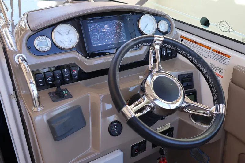  Yacht Photos Pics 2018 Regal 28 Express boat dashboard with steering wheel and navigation controls.
