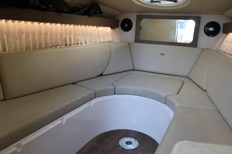  Yacht Photos Pics Interior of 2018 Regal 28 Express boat with beige seating and wood flooring.