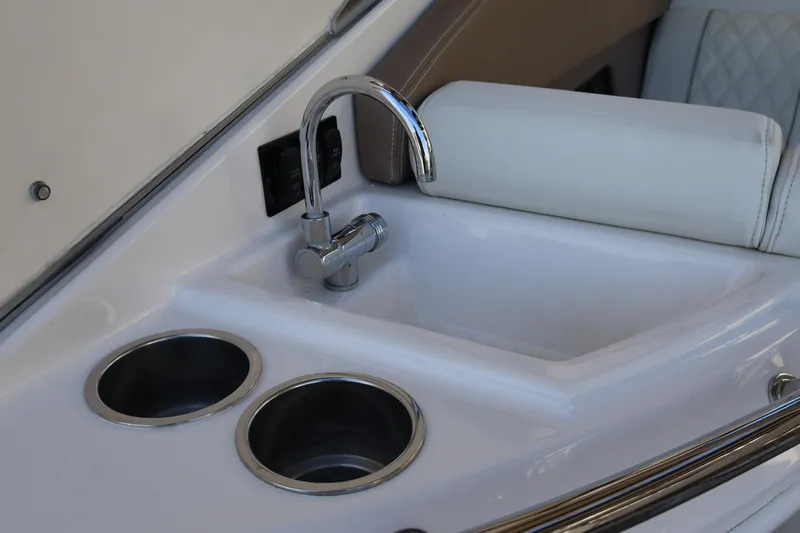  Yacht Photos Pics 2018 Regal 28 Express boat sink with faucet and cup holders.
