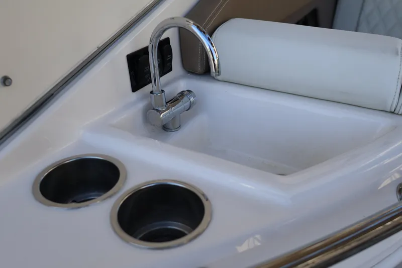  Yacht Photos Pics Compact sink and cup holders on 2018 Regal 28 Express boat interior.