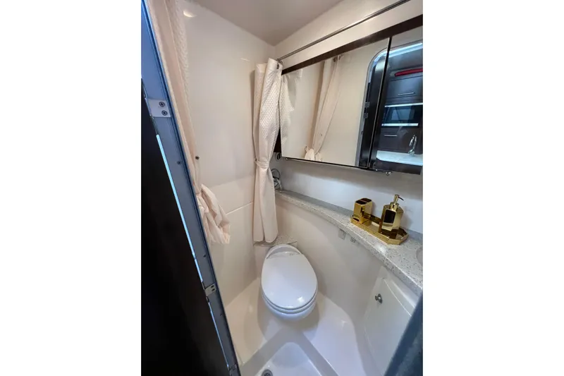  Yacht Photos Pics Compact bathroom in 2018 Regal 28 Express boat with modern fixtures and mirror.