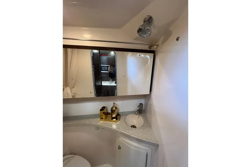  Yacht Photos Pics 2018 Regal 28 Express bathroom with mirror, sink, and modern fixtures.