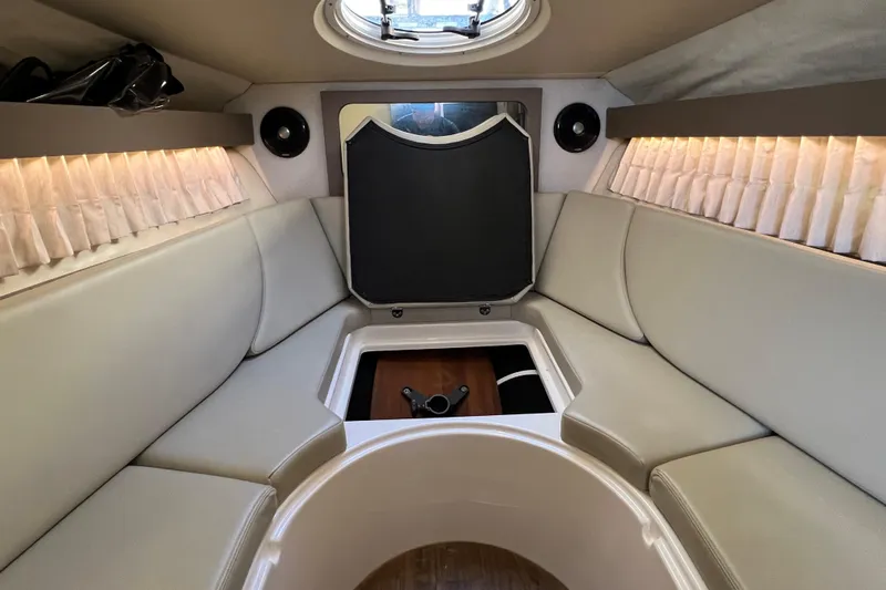  Yacht Photos Pics 2018 Regal 28 Express boat interior with beige seating and ambient lighting.
