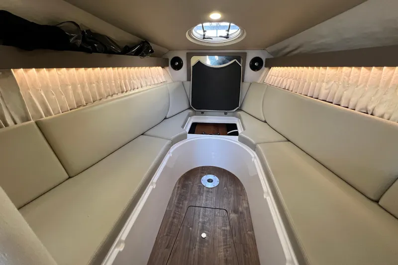  Yacht Photos Pics 2018 Regal 28 Express boat interior with beige seating and wood flooring.