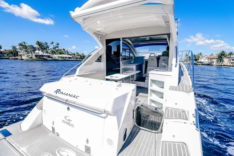  Yacht Photos Pics Luxury Evolve 400HT yacht cruising on a sunny day, showcasing sleek design and spacious deck.