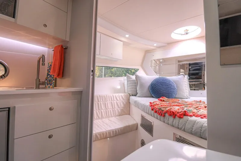  Yacht Photos Pics Luxurious interior of 2021 Evolve 400HT yacht with cozy bed and modern kitchenette.