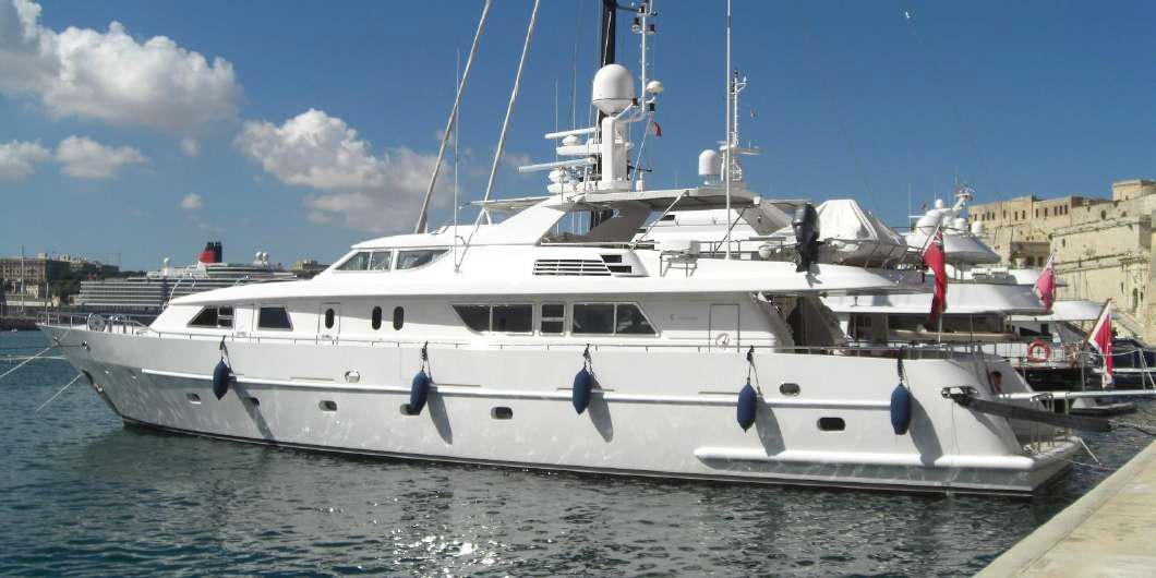 Codecasa 32m 1999 yacht docked at marina on a sunny day.