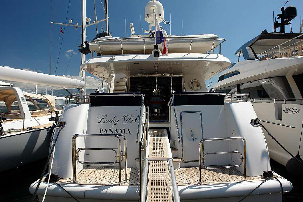 Luxury yacht Codecasa 32m, 1999 model, docked in a marina, rear view.