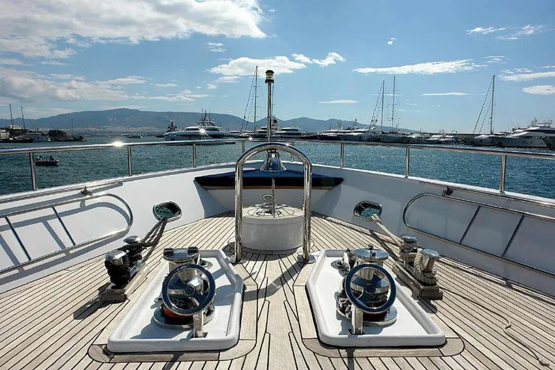  Yacht Photos Pics Codecasa 32m yacht deck, 1999 model, with marina and mountains in the background.