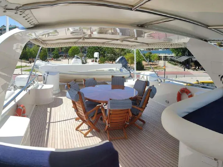  Yacht Photos Pics Codecasa 32m 1999 yacht deck with dining area and seating.