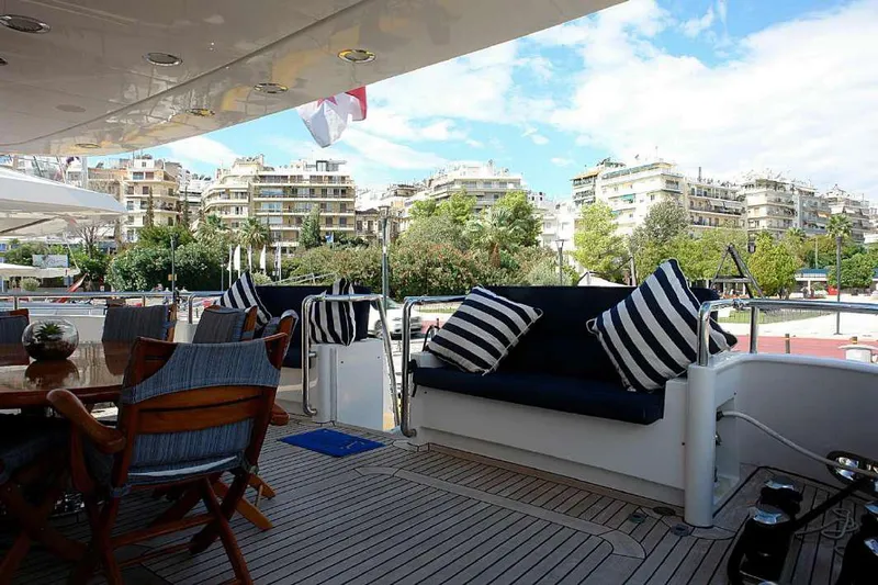  Yacht Photos Pics Luxury Codecasa 32m yacht deck with seating area, docked in a scenic marina, 1999 model.