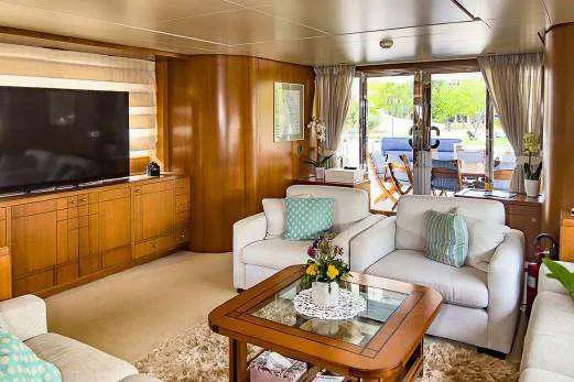  Yacht Photos Pics Luxurious Codecasa 32m 1999 yacht interior with plush seating, large TV, and elegant decor.