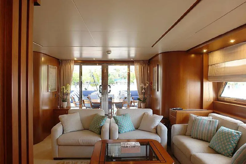  Yacht Photos Pics Luxurious interior of 1999 Codecasa 32m yacht with elegant seating and wooden finishes.