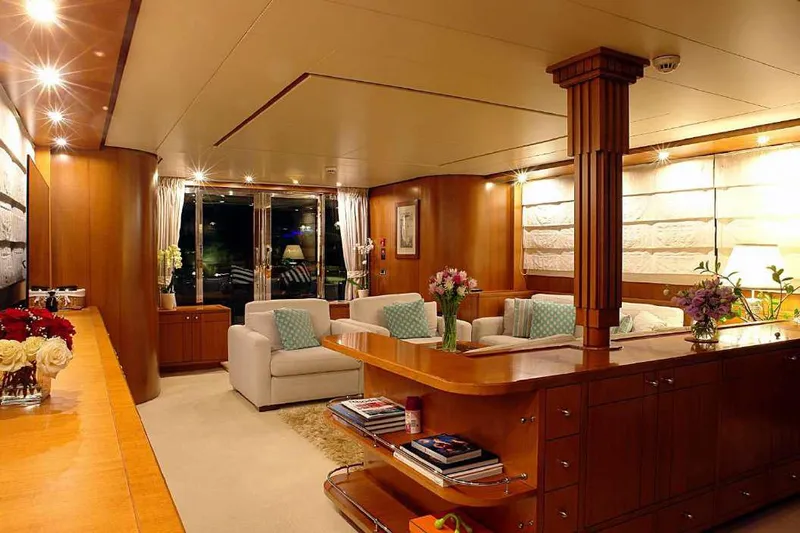  Yacht Photos Pics Luxurious interior of 1999 Codecasa 32m yacht with elegant wooden furnishings and cozy seating area.