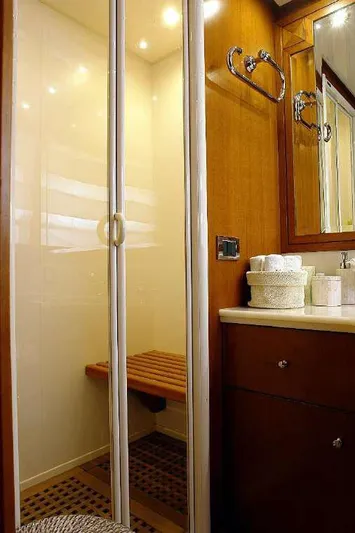  Yacht Photos Pics Luxurious bathroom in 1999 Codecasa 32m yacht with wooden accents and modern shower.