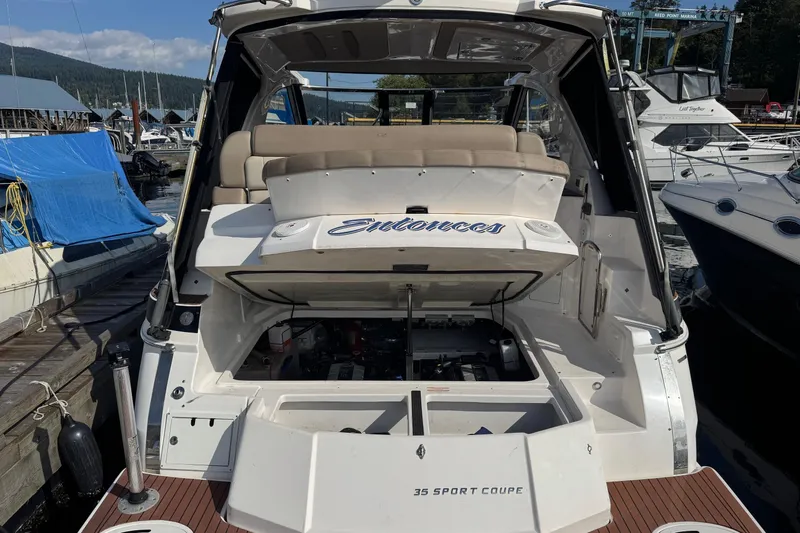  Yacht Photos Pics 2013 Regal 35 Sport Coupe docked, showcasing open engine compartment and seating area.