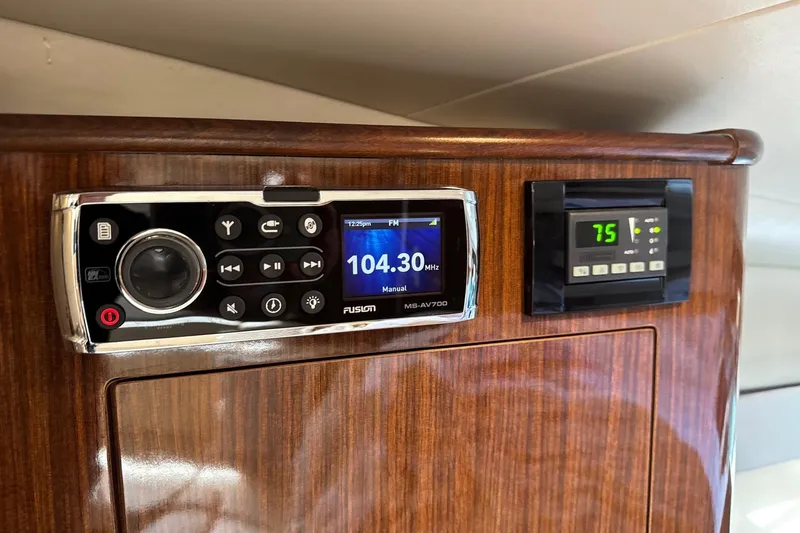  Yacht Photos Pics Control panel of a 2013 Regal 35 Sport Coupe with radio and temperature display.
