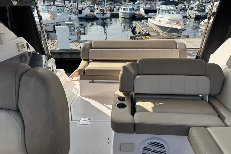  Yacht Photos Pics 2013 Regal 35 Sport Coupe interior with beige seating, docked at marina.