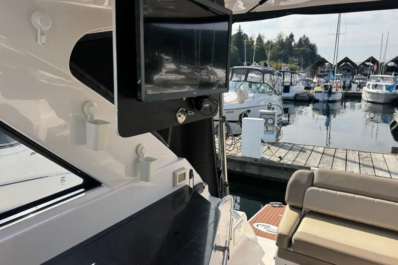  Yacht Photos Pics 2013 Regal 35 Sport Coupe interior with TV, docked at marina.